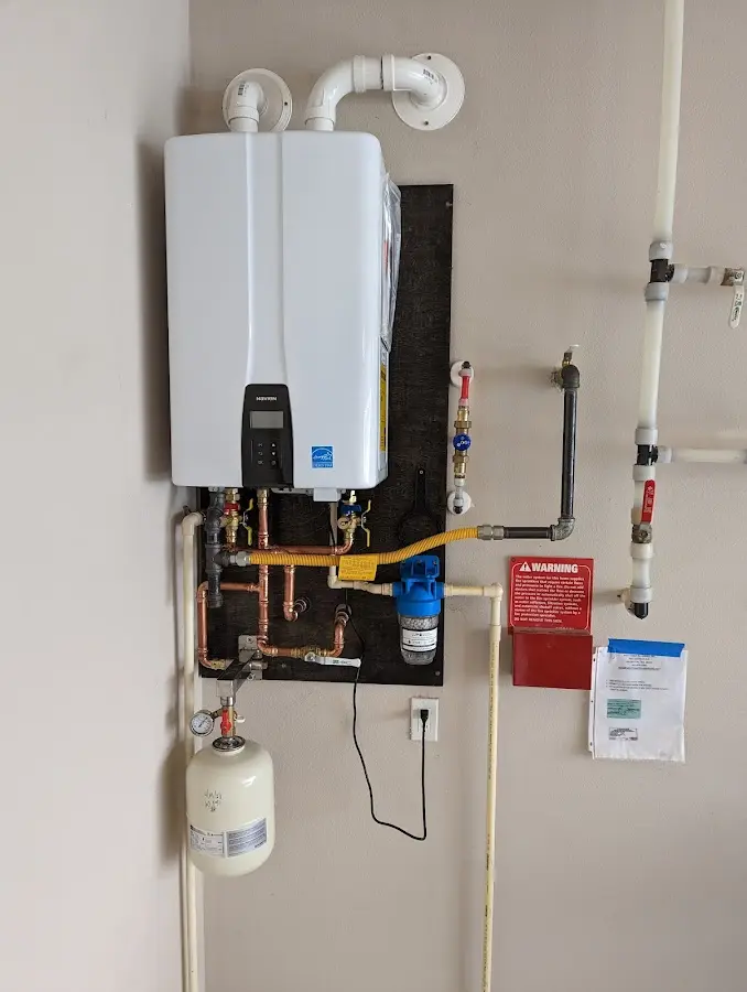 Professional plumber installing copper piping in a West Earl home